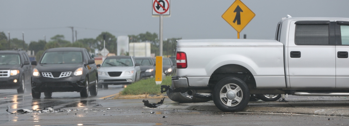 A car crash scene on a rainy day.