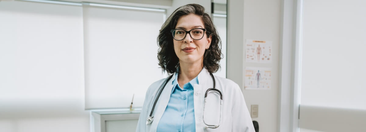 mature, female doctor standing in hallway of hospital