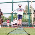 kid running on field doing drills