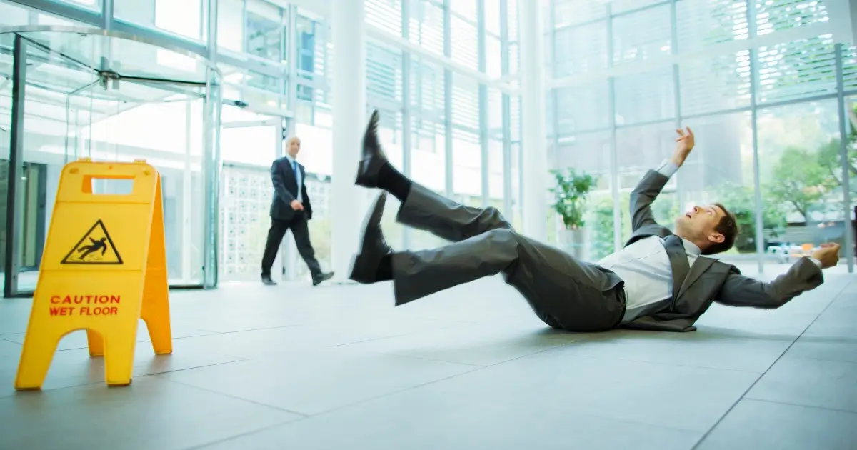 man in suit on floor after slip-and-fall